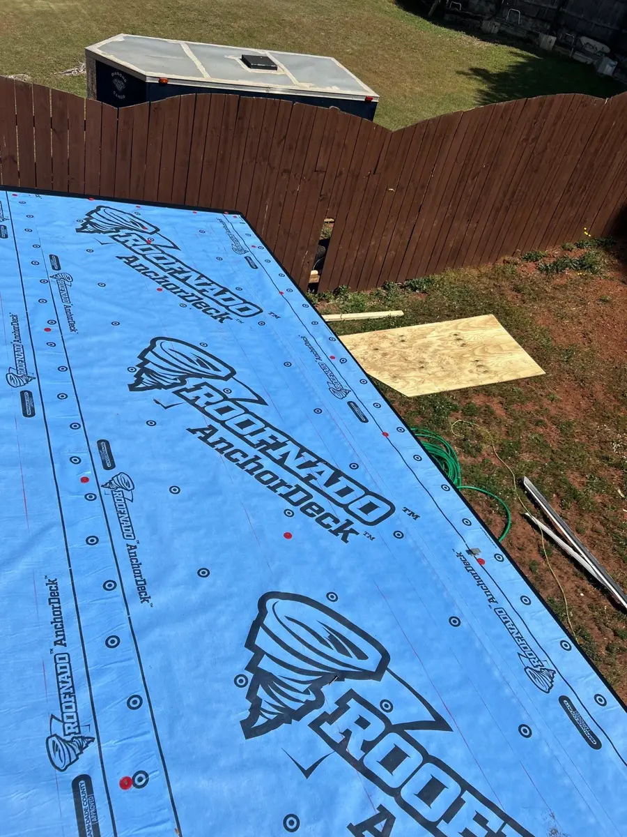 Blue synthetic underlayment covering newly installed roof decking, Southern Premier Roofing work near Norcross GA