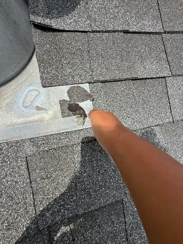 Worker hands installing flashing around roof vent on shingles, Southern Premier Roofing work near North High Shoals GA
