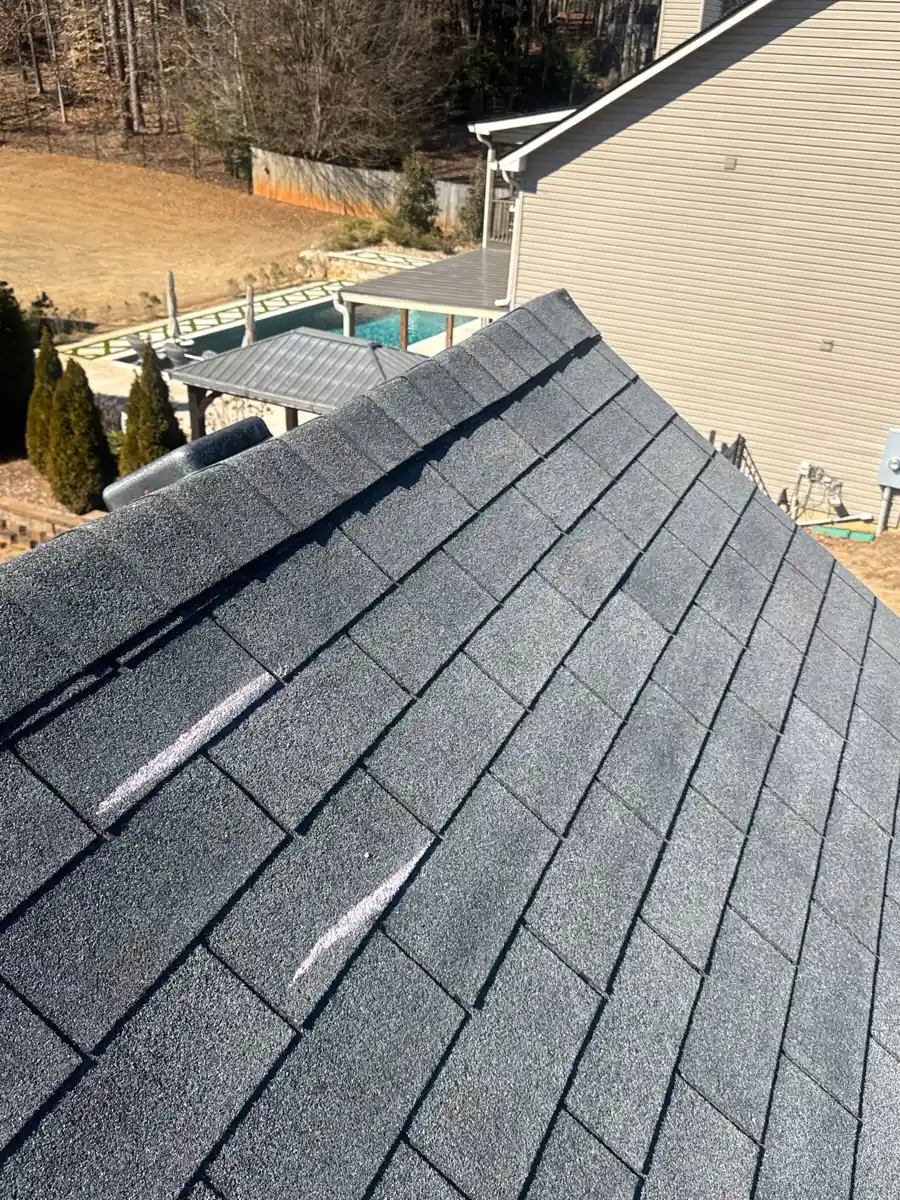 Finished shingles cover sloped roof with neat ridge detailing, Southern Premier Roofing work near Oakwood GA