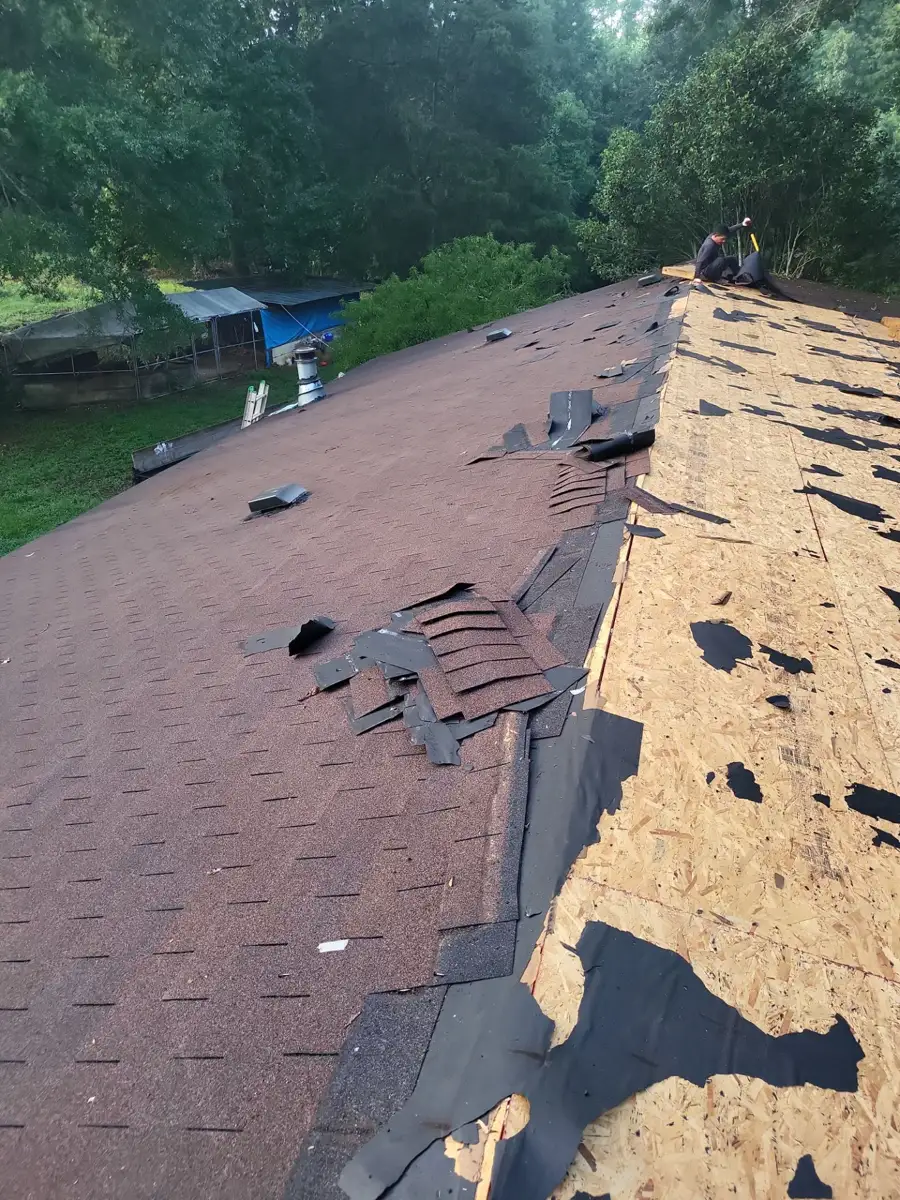 Partial roof tearoff showing exposed decking beside remaining shingles, Southern Premier Roofing work near Oxford GA