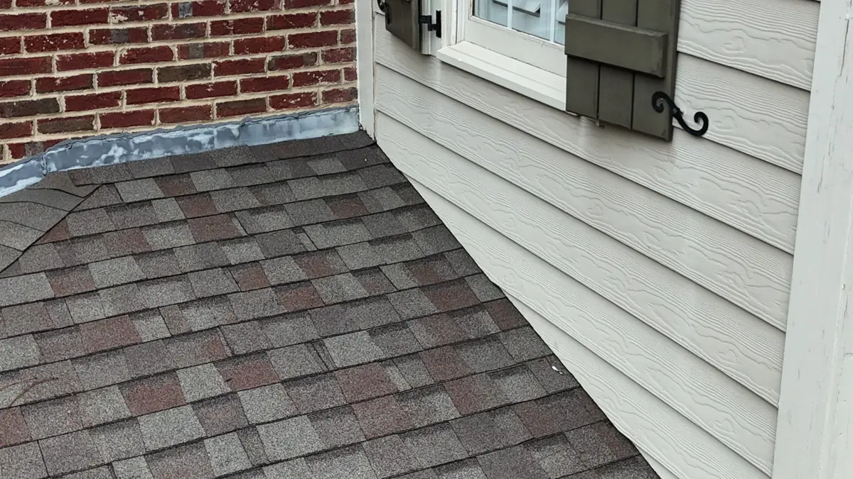 Low roof shingles meeting wall with visible edge and flashing detail, Southern Premier Roofing work near Peachtree Corners GA