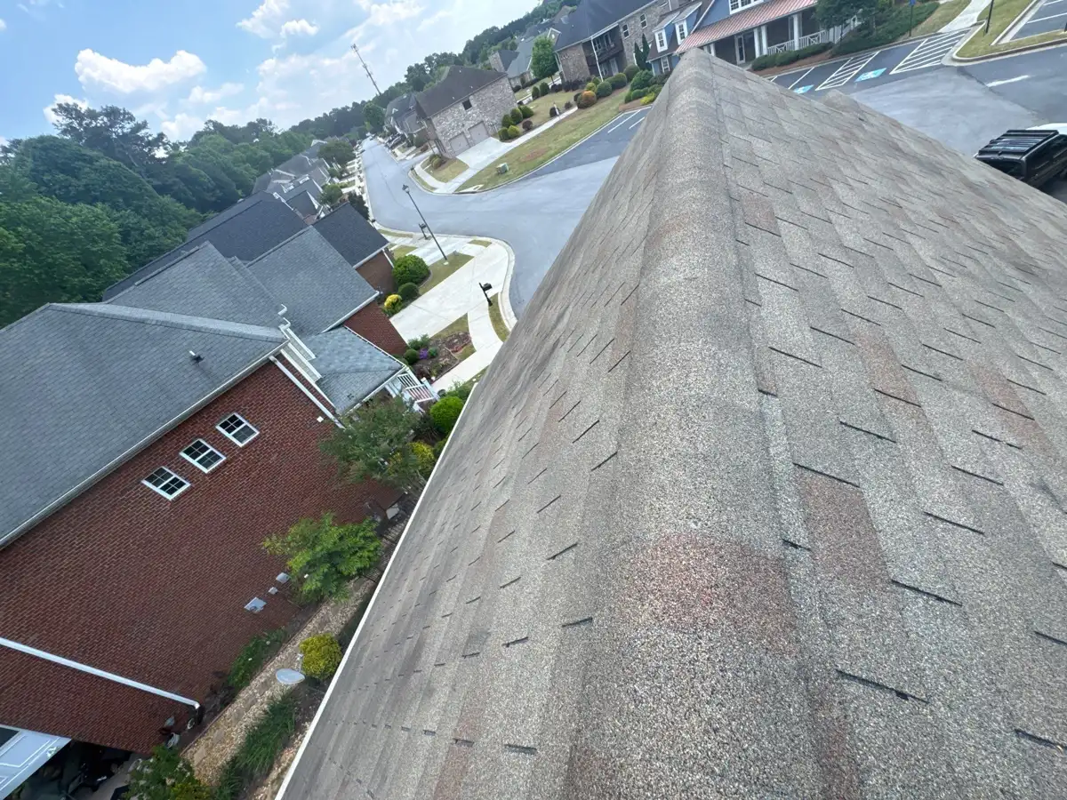 Weathered shingle roof ridge overlooking neighboring houses and streets, Southern Premier Roofing work near Pendergrass GA