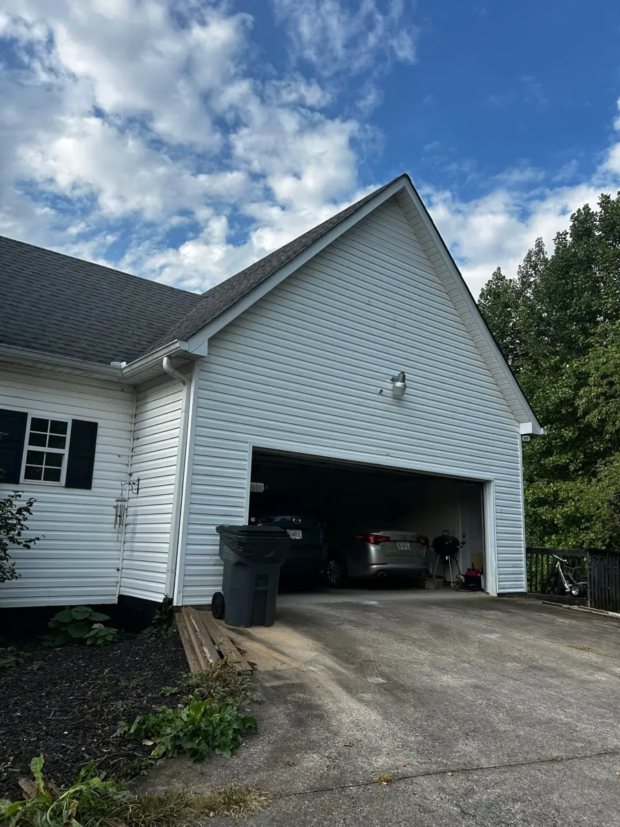 Gable roof above garage with dark shingles and white siding, Southern Premier Roofing work near Rutledge GA