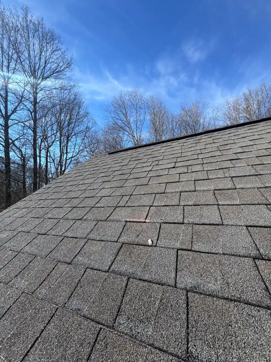 Broad gray shingle roof slope under blue sky and trees, Southern Premier Roofing work near Snellville GA