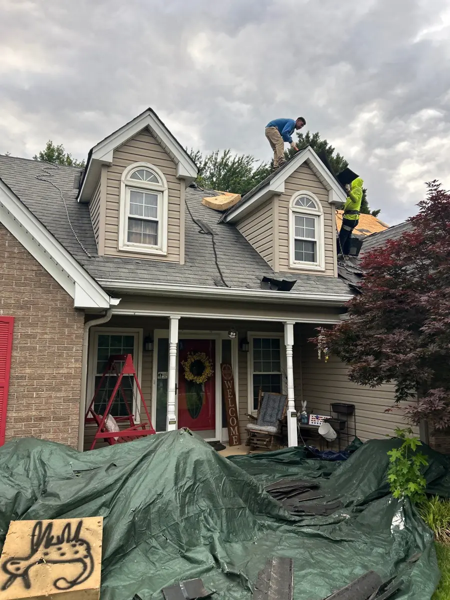 Worker installing shingles on a detailed front roof, Southern Premier Roofing work near Snellville GA