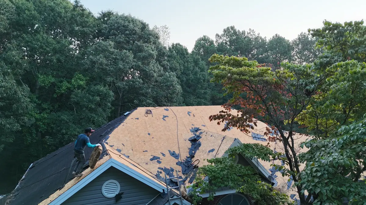 Wide view shows roof tearoff with exposed decking and remaining shingles, Southern Premier Roofing work near Statham GA