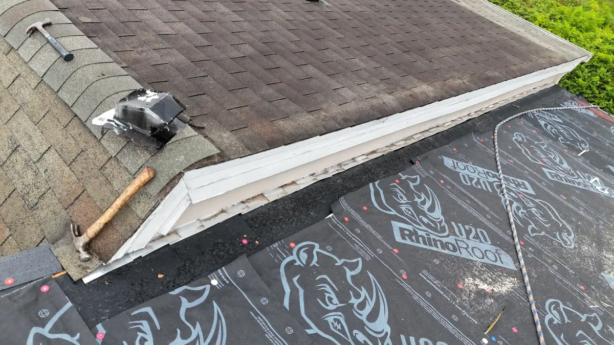 Roof underlayment installed below remaining shingles along roof edge, Southern Premier Roofing work near Sugar Hill GA