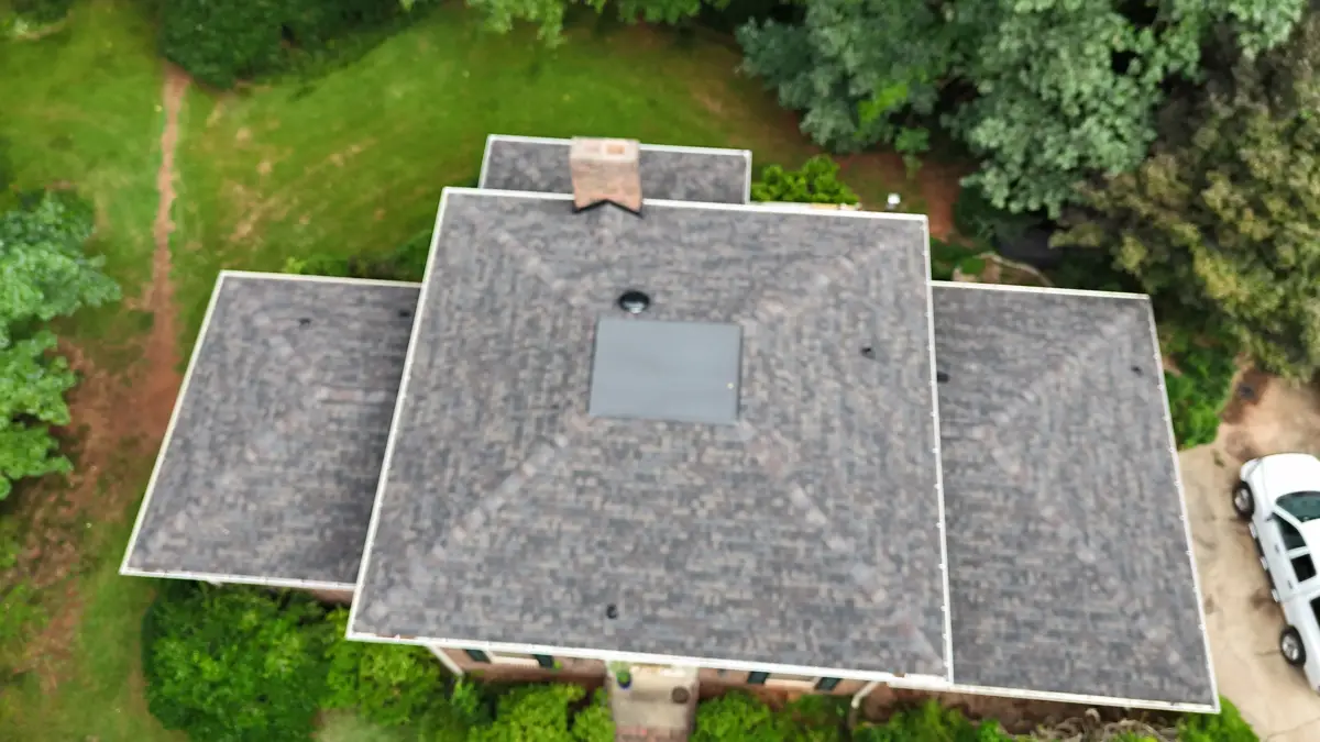 Aerial view of completed architectural shingle roof surrounded by trees, Southern Premier Roofing work near Suwanee GA