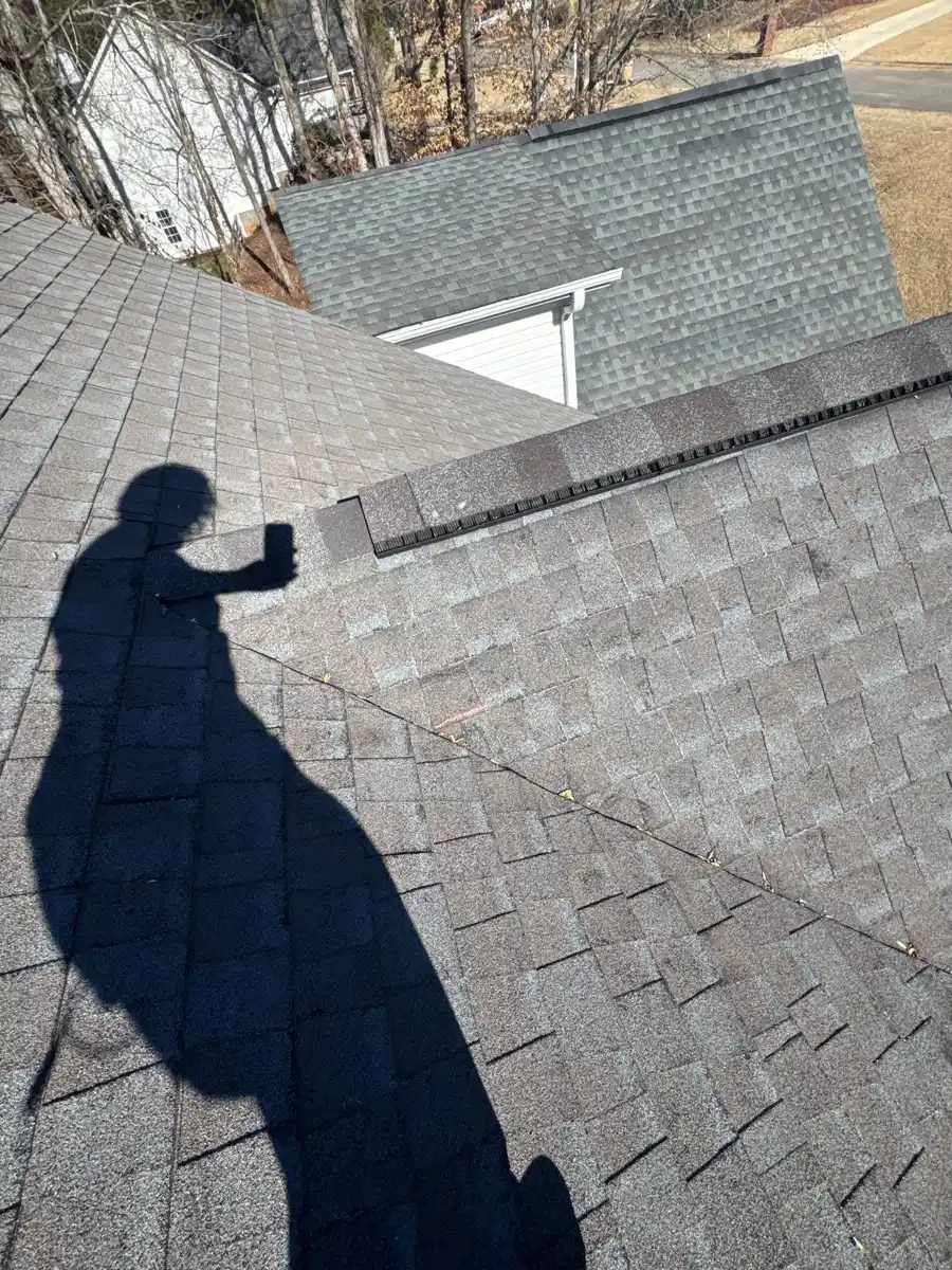 Roof ridge vent installed across shingle-covered intersecting roof sections, Southern Premier Roofing work near Suwanee GA