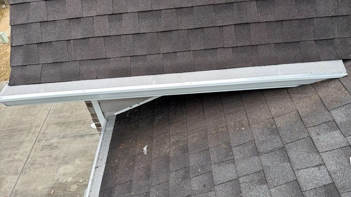 Close view of white roof flashing along intersecting shingle surfaces, Southern Premier Roofing work near Suwanee GA