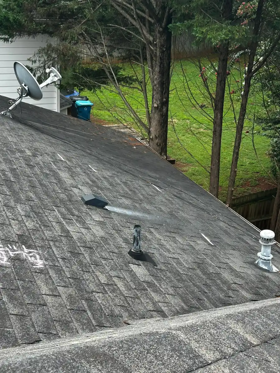 Roof slope with shingles, satellite dish, and plumbing vent, Southern Premier Roofing work near Walnut Grove GA