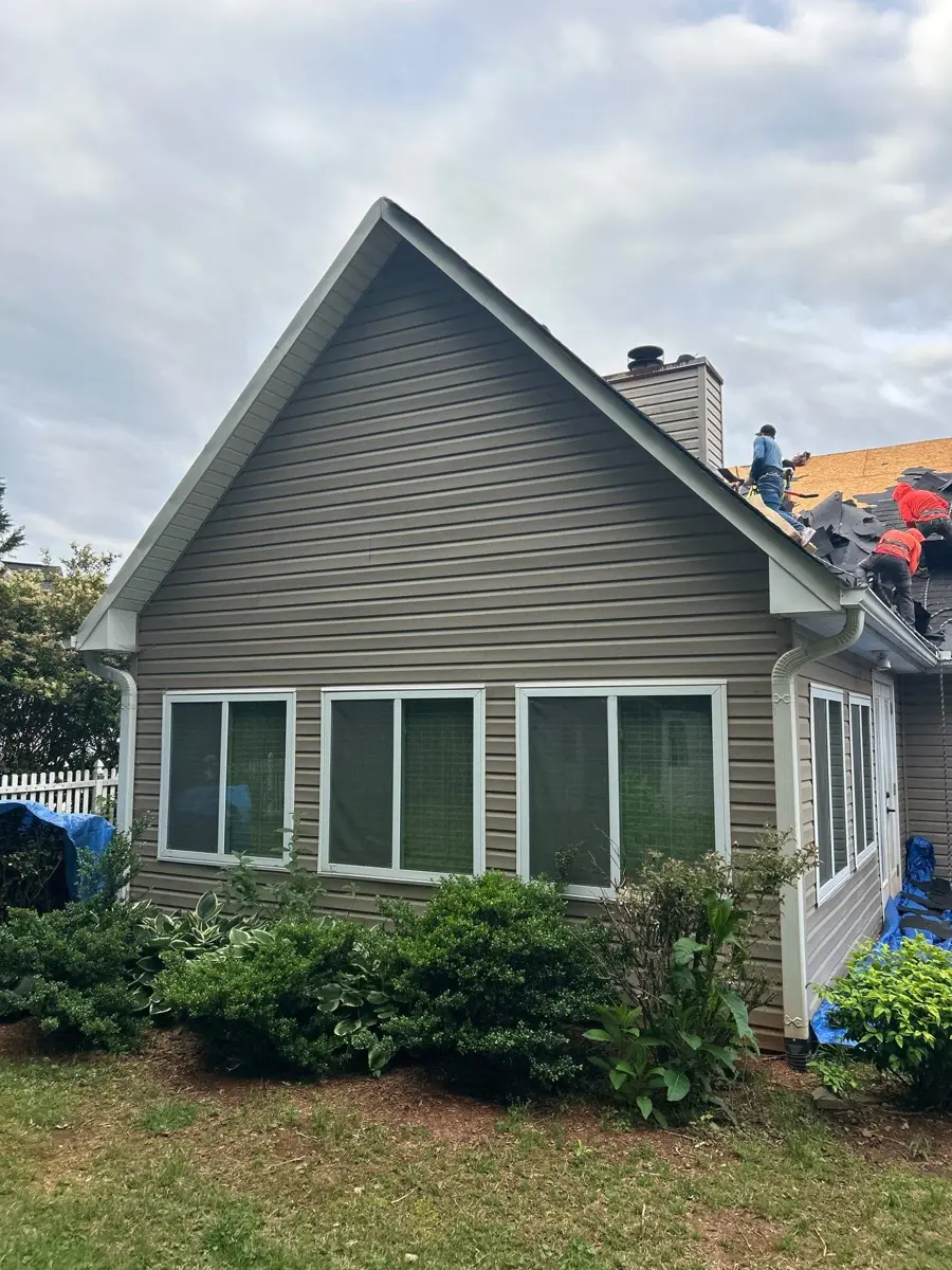 Completed dark roof covering house exterior and dormers, Southern Premier Roofing work near Watkinsville GA