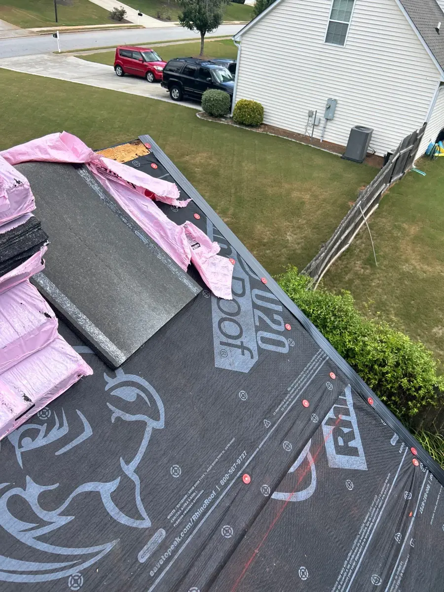 Underlayment and bundled shingles arranged across partially prepared roof, Southern Premier Roofing work near Watkinsville GA