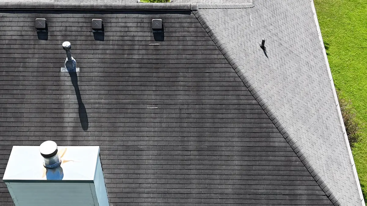 Aerial view of dark shingle roof with vents and chimney, Southern Premier Roofing work near Winder GA