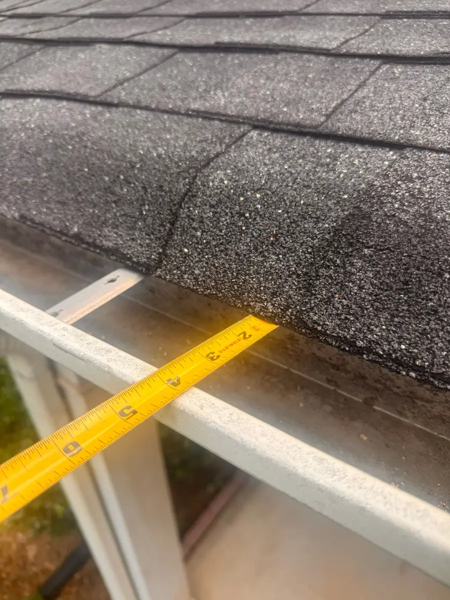 Roof surface near eave shows wear and exposed measuring tool, Southern Premier Roofing work near Arcade GA