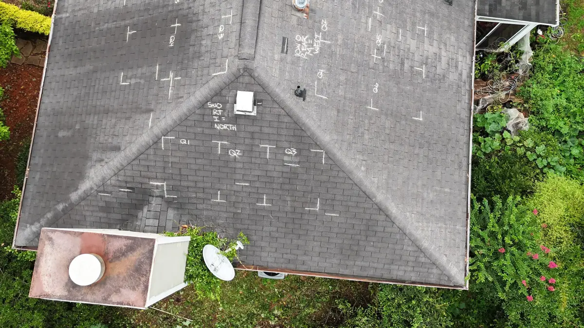 Aerial view of weathered shingle roof with multiple rooftop fixtures, Southern Premier Roofing work near Arnoldsville GA