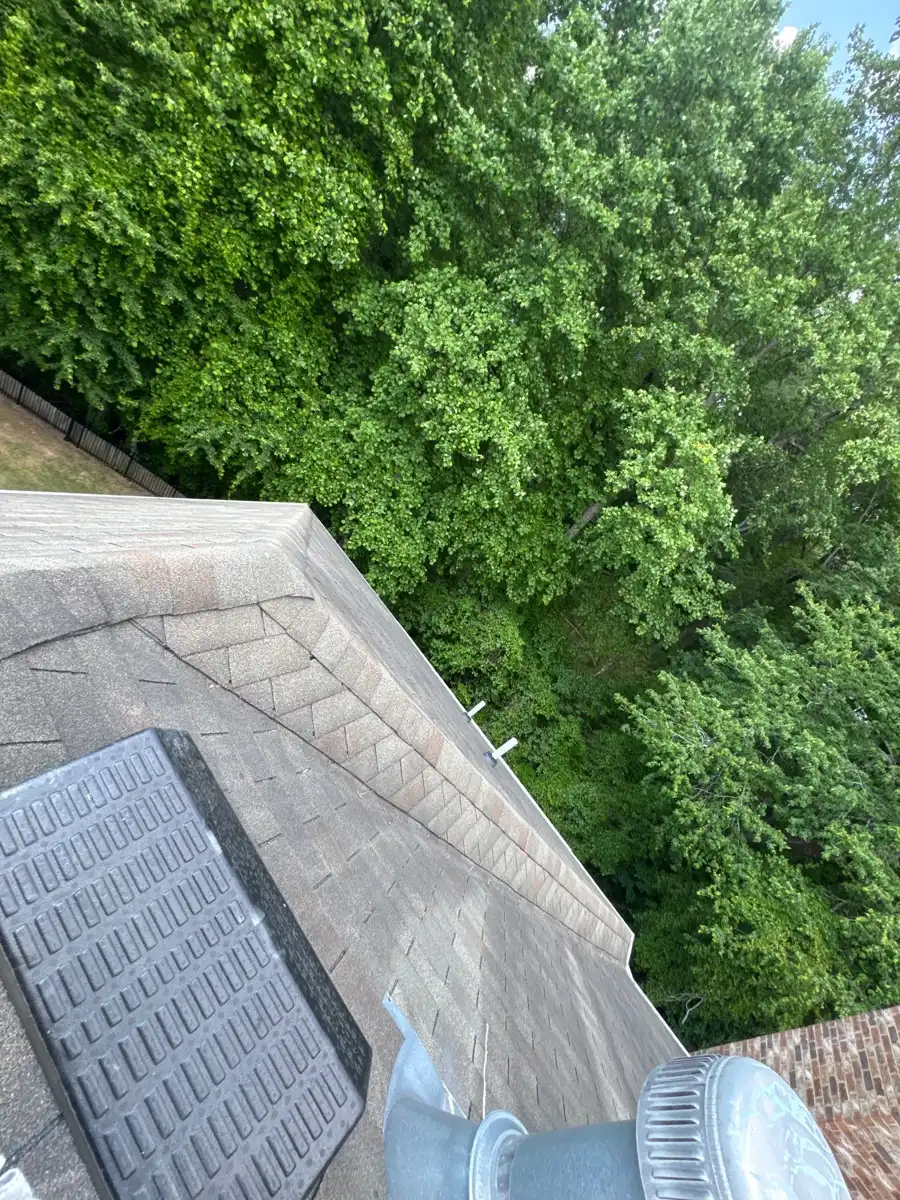 Shingle roof section with rectangular skylight and trees, Southern Premier Roofing work near Auburn GA