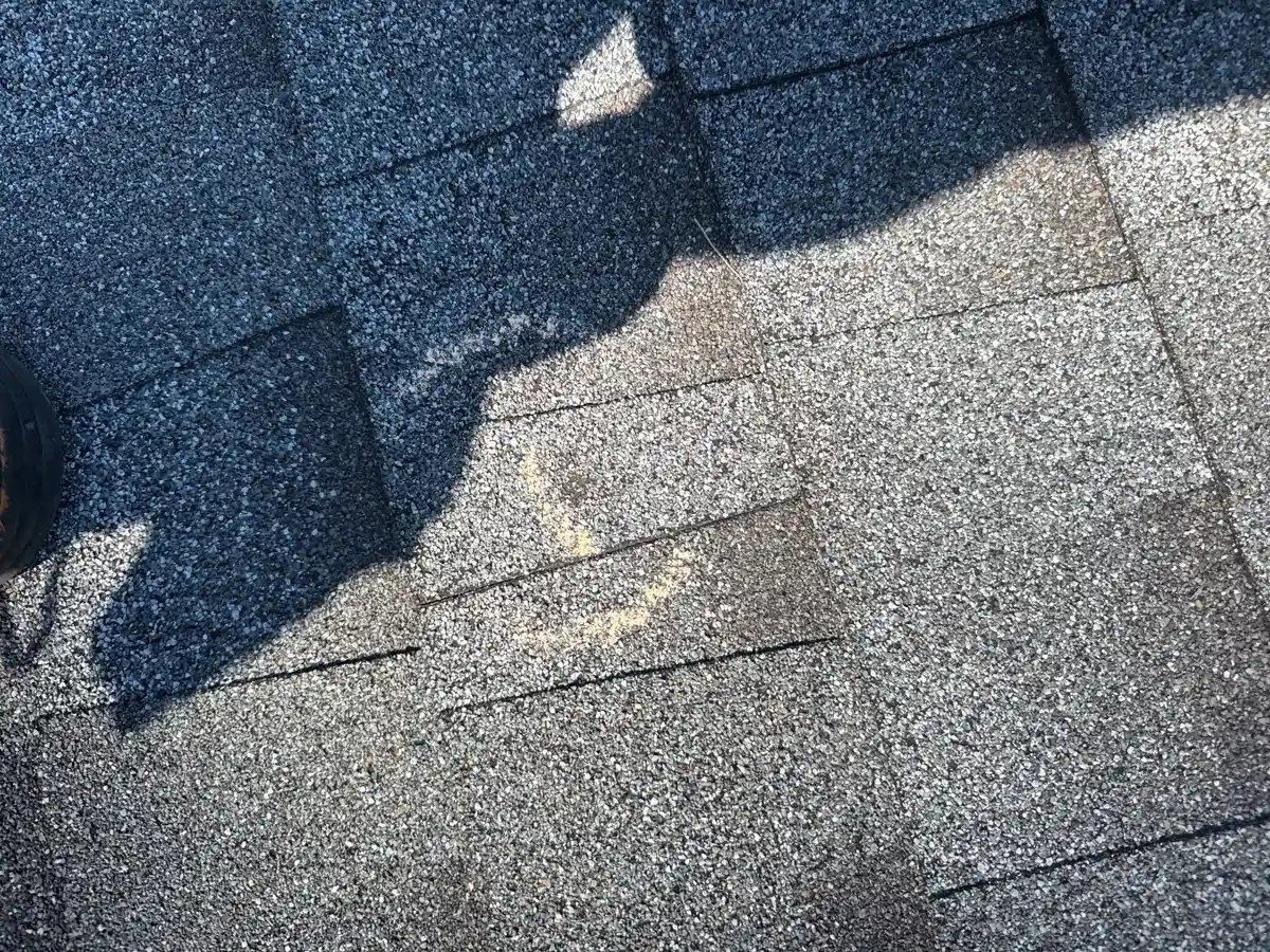 Sunlit shingles show marked areas and visible surface wear, Southern Premier Roofing work near Berkeley Lake GA