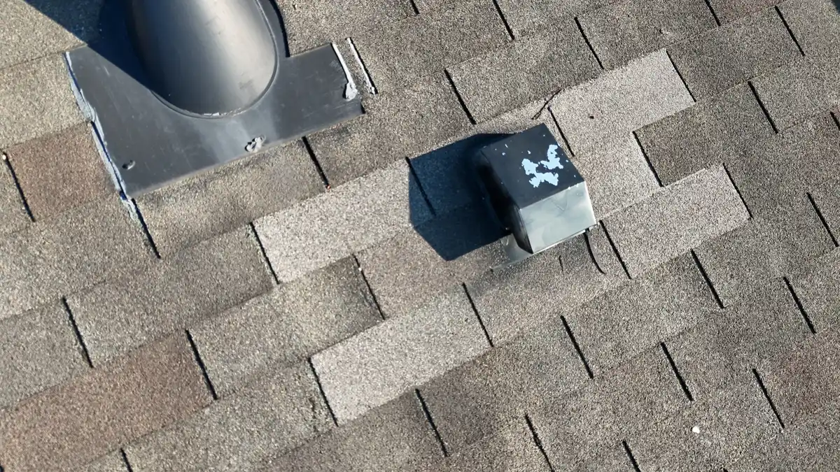 Roof vent pipe with metal flashing surrounded by asphalt shingles, Southern Premier Roofing work near Berkeley Lake GA