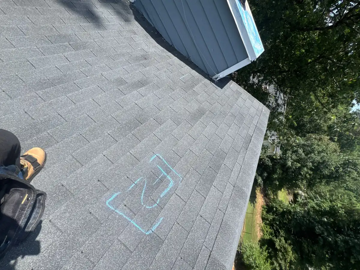 Completed architectural shingle roof beside blue sided wall, Southern Premier Roofing work near Berkeley Lake GA
