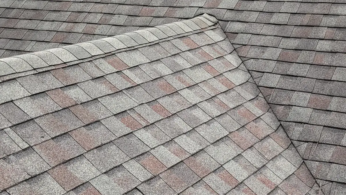 Shingles surrounding raised roof intersection with visible ridge transition, Southern Premier Roofing work near Between GA