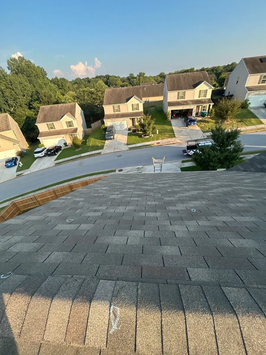 Completed shingle roof overlooking neighboring homes and tree-lined streets, Southern Premier Roofing work near Between GA