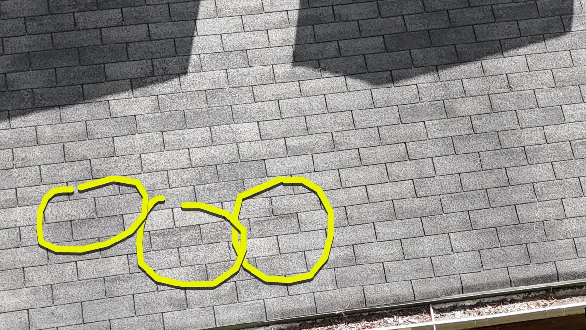 Close view shows multiple highlighted irregularities in roof shingles, Southern Premier Roofing work near Bogart GA
