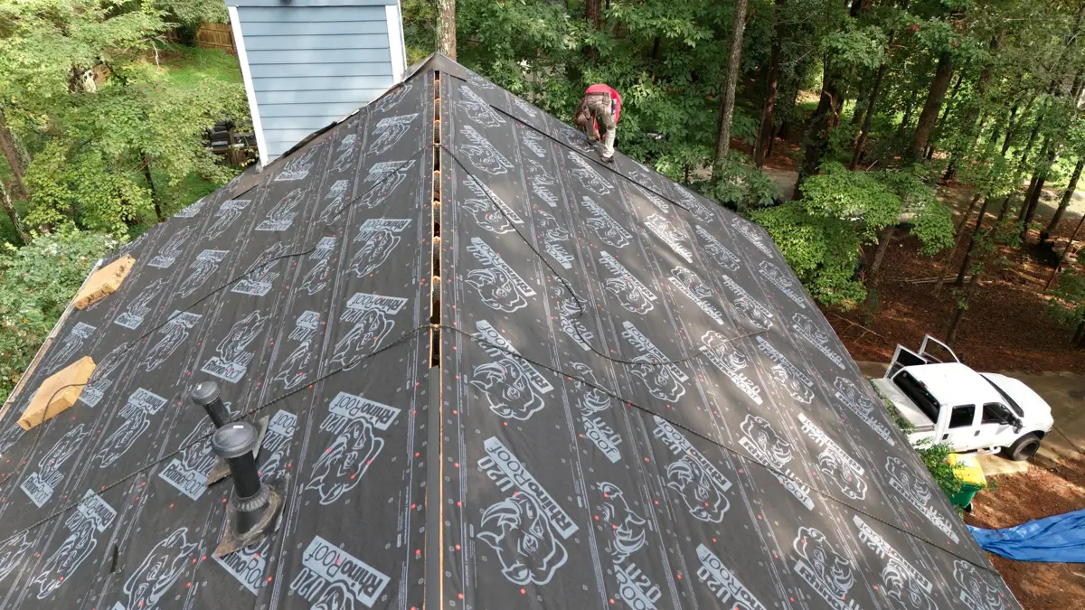 Roof covered with branded underlayment along central ridge, Southern Premier Roofing work near Bogart GA