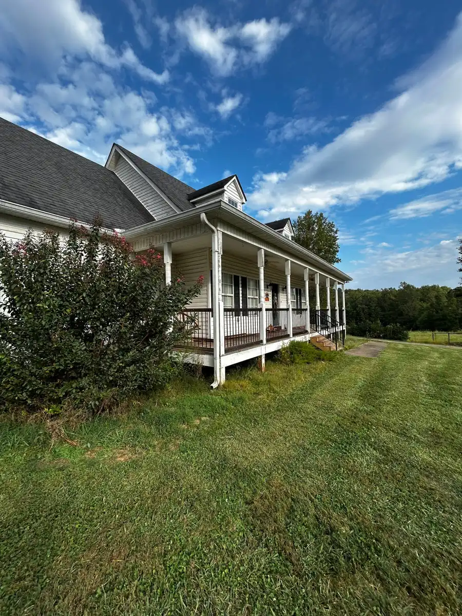 Wide view of shingled roof above a long covered porch, Southern Premier Roofing work near Braselton GA
