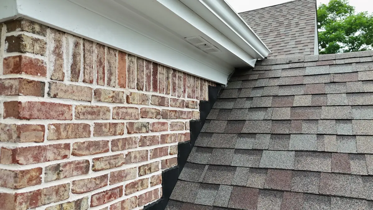 Shingles meet brick wall and eaves with carefully finished flashing, Southern Premier Roofing work near Carl GA