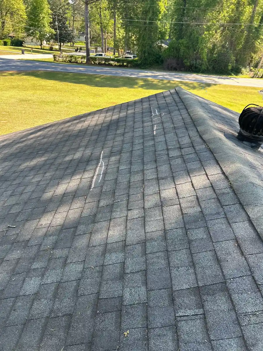 Broad roof surface with aligned gray shingles and surrounding yard, Southern Premier Roofing work near Commerce GA