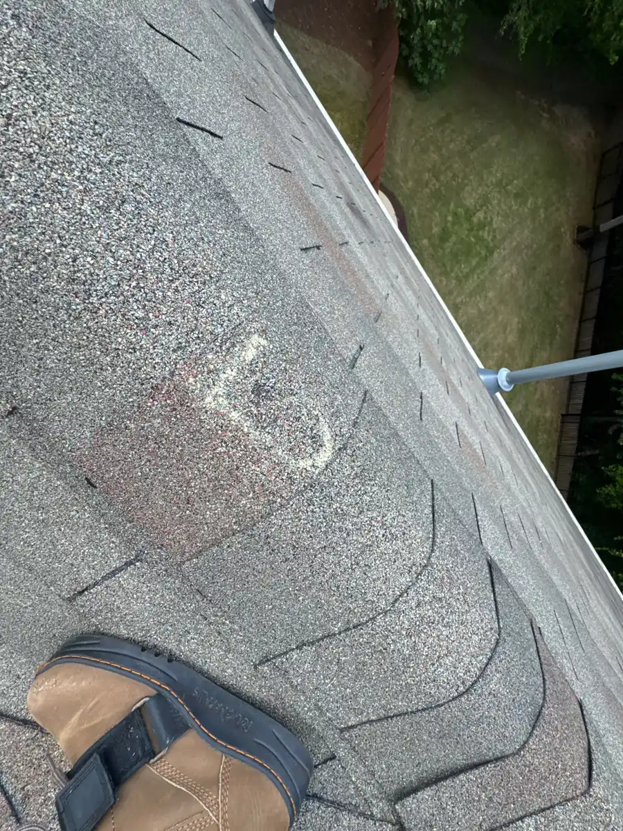 Close view of worn shingles with patching and roof edge, Southern Premier Roofing work near Conyers GA