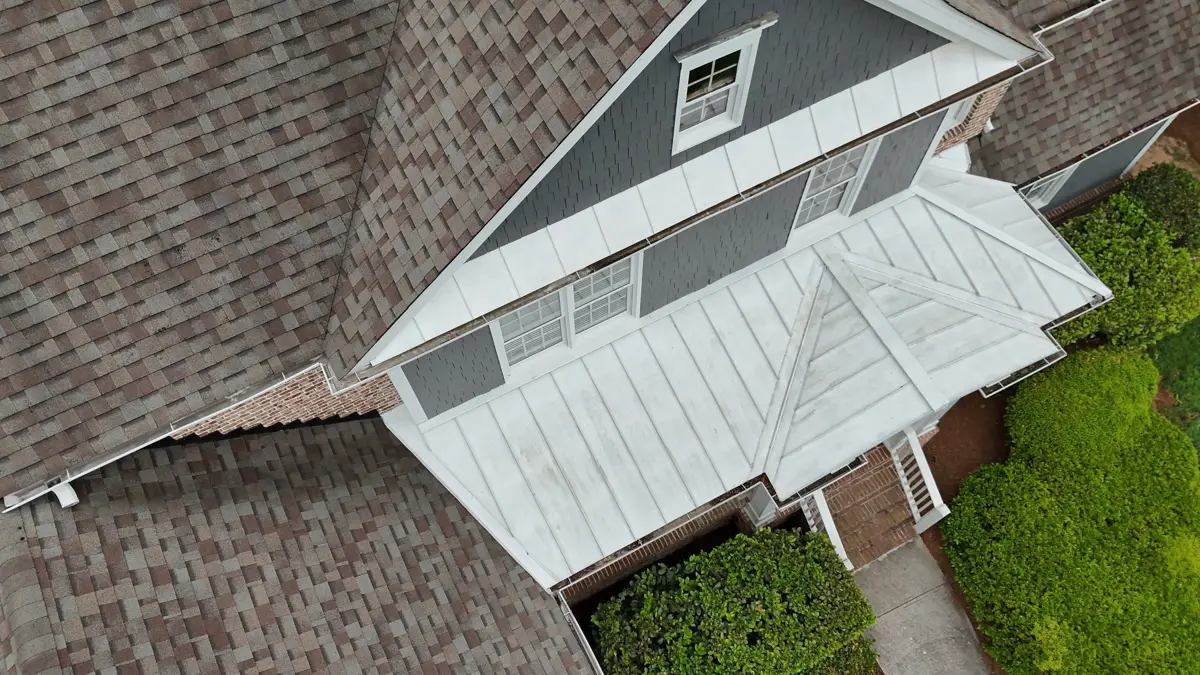 Wide view shows completed shingled roof surrounding white dormer structure, Southern Premier Roofing work near Conyers GA