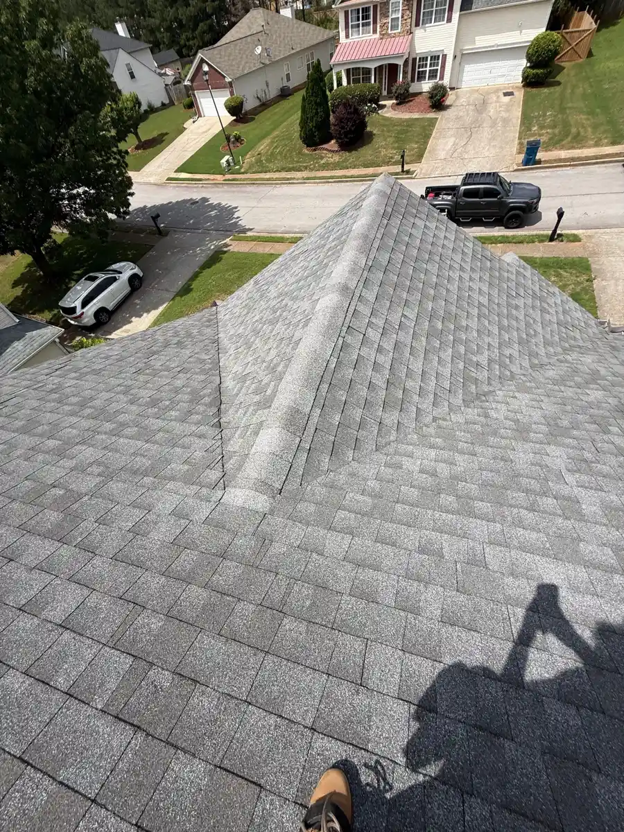 Gray shingle roof viewed from above with central ridge and neighborhood beyond, Southern Premier Roofing work near Dacula GA