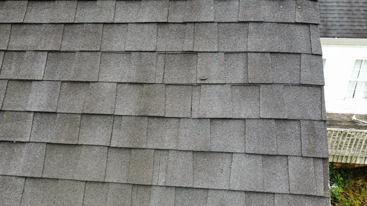 Close view of weathered overlapping roof shingles with visible wear, Southern Premier Roofing work near Flowery Branch GA