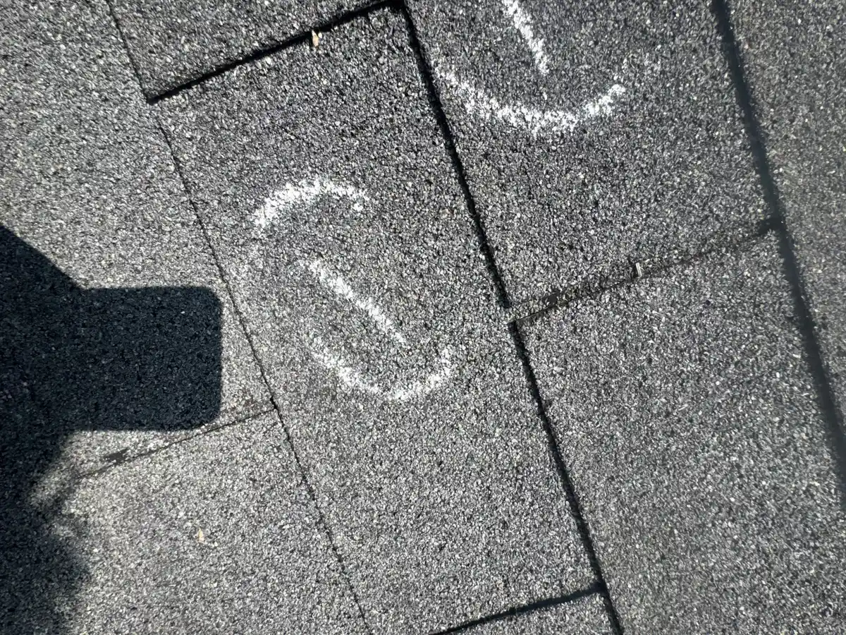 Close view of marked asphalt shingles showing roof surface damage, Southern Premier Roofing work near Gainesville GA