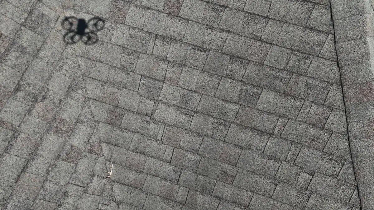 Gray shingles showing a dark irregular roof surface mark, Southern Premier Roofing work near Good Hope GA