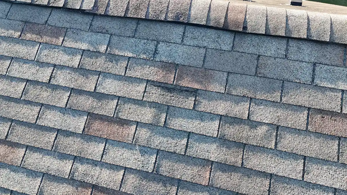Close view of weathered asphalt shingles with visible granule wear, Southern Premier Roofing work near Grayson GA