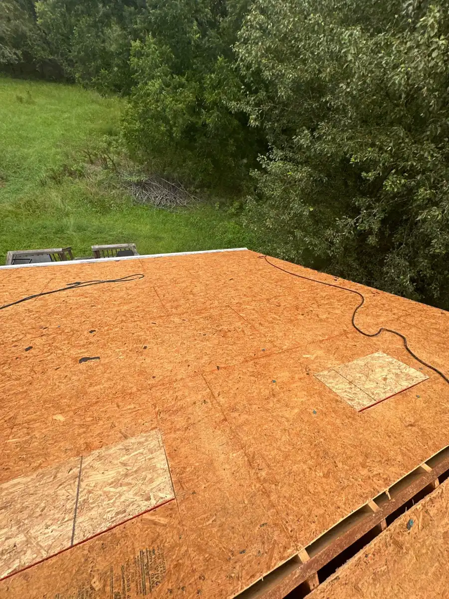 Broad exposed roof decking with seams, patches, and ridge opening, Southern Premier Roofing work near Grayson GA