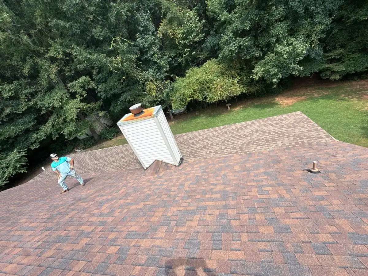 Completed shingle roof viewed from above beside chimney, Southern Premier Roofing work near Grayson GA