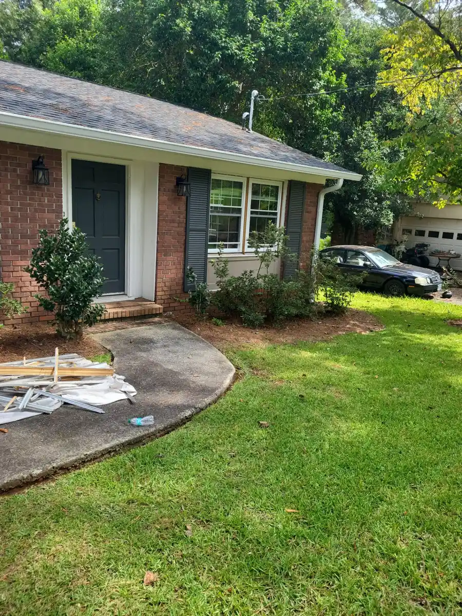 Completed shingle roof on brick ranch house with landscaped front yard, Southern Premier Roofing work near Homer GA