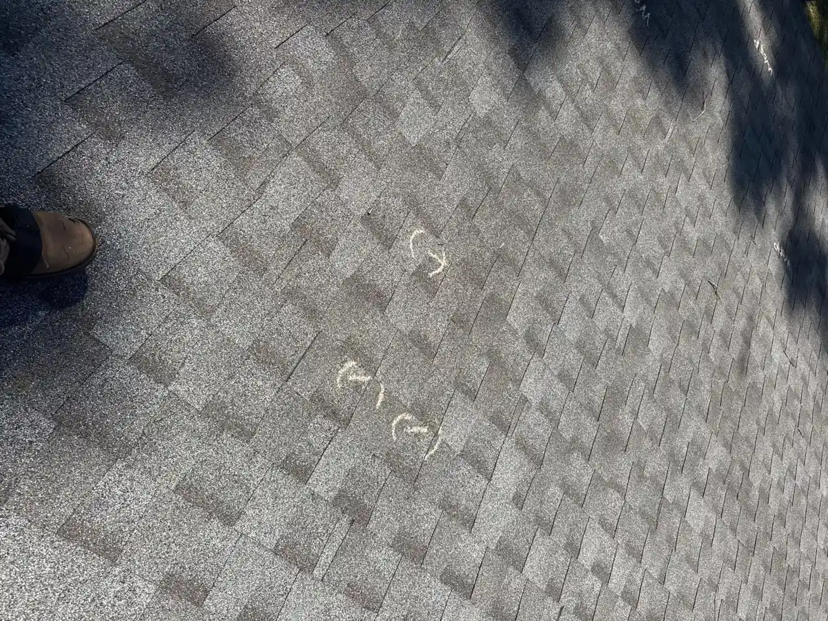 Roof surface shows multiple marked areas amid shingle wear, Southern Premier Roofing work near Hoschton GA