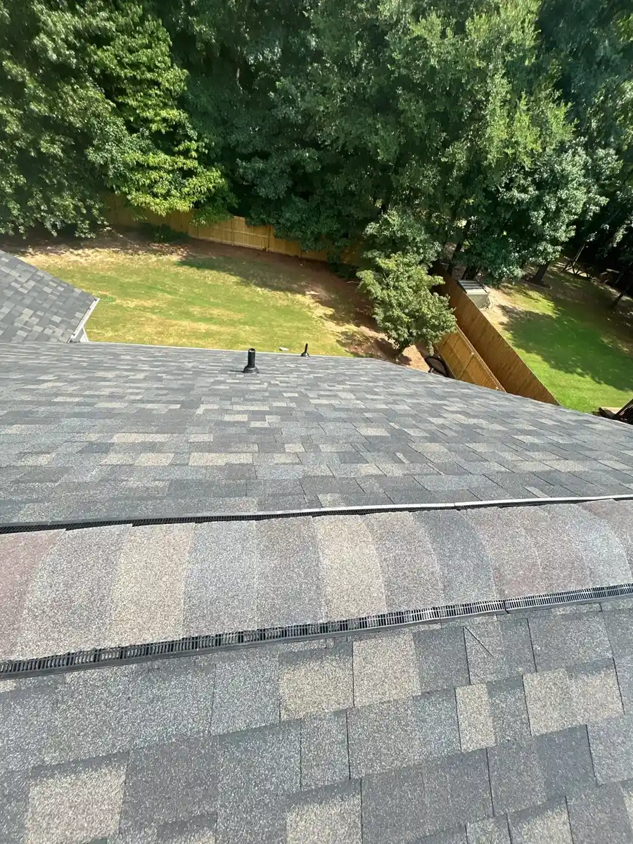 Roof ridge showing installed vent and overlapping shingle courses, Southern Premier Roofing work near Ila GA