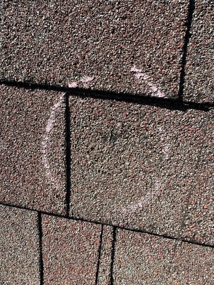Closeup of granular shingles showing a circular inspection mark, Southern Premier Roofing work near Jefferson GA
