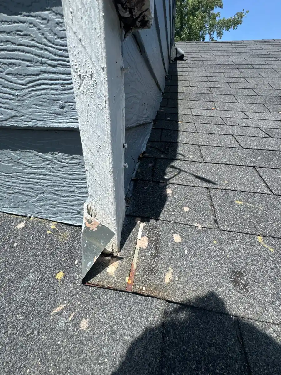 Wall intersection showing roof flashing and shingle edges, Southern Premier Roofing work near Jefferson GA