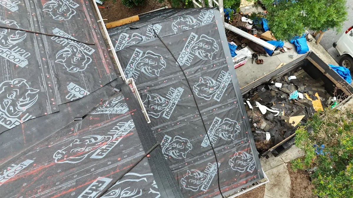 Black patterned roofing underlayment covers multiple sloped roof sections, Southern Premier Roofing work near Jersey GA