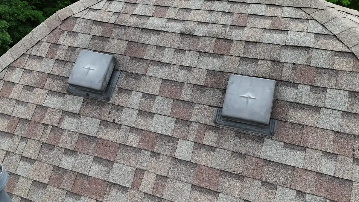 Close view of completed shingle roof with two roof vents, Southern Premier Roofing work near Lilburn GA