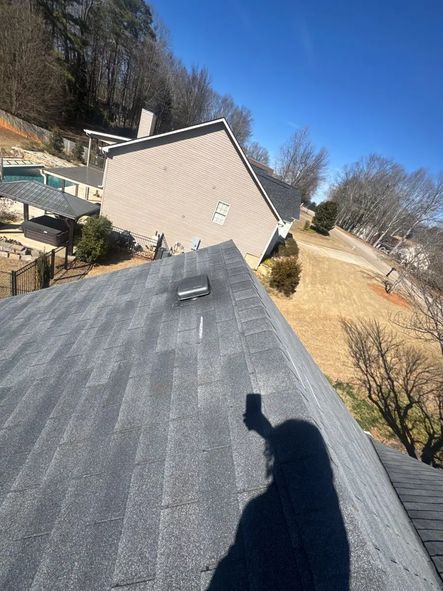 Gray shingle roof slope with neighboring homes and trees visible, Southern Premier Roofing work near Lula GA
