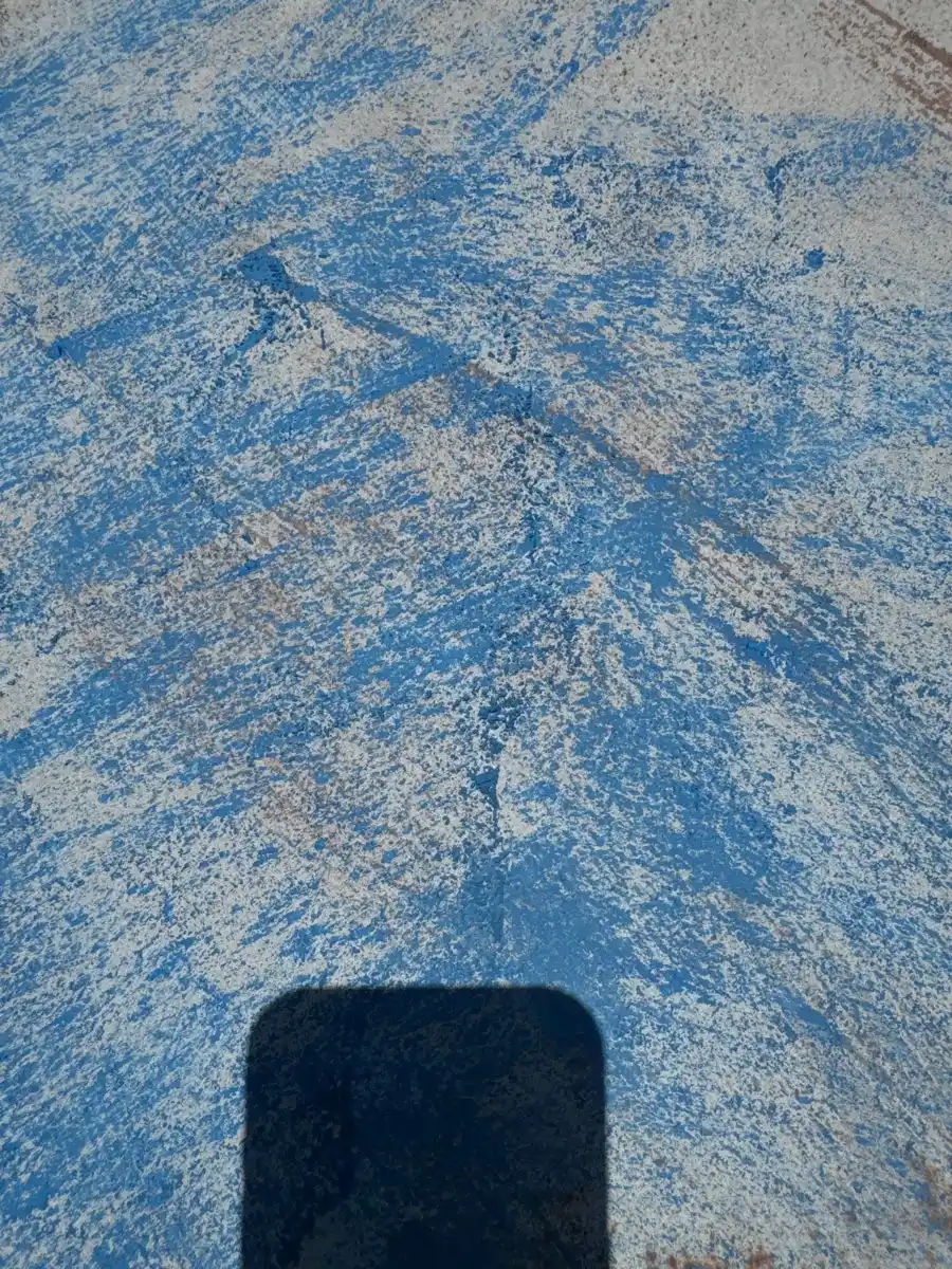 Textured blue roof surface showing extensive coating deterioration, Southern Premier Roofing work near Monroe GA