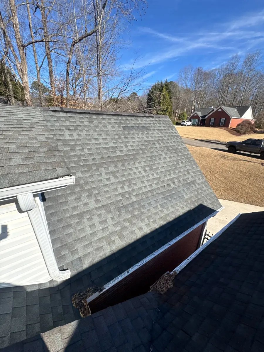 Gray shingle roof section viewed from above beside adjacent roof, Southern Premier Roofing work near Mulberry GA